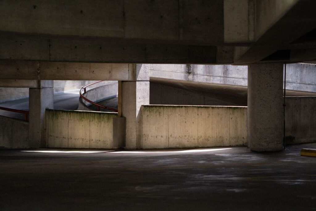 Concrete parking garage with a curved ramp and support columns