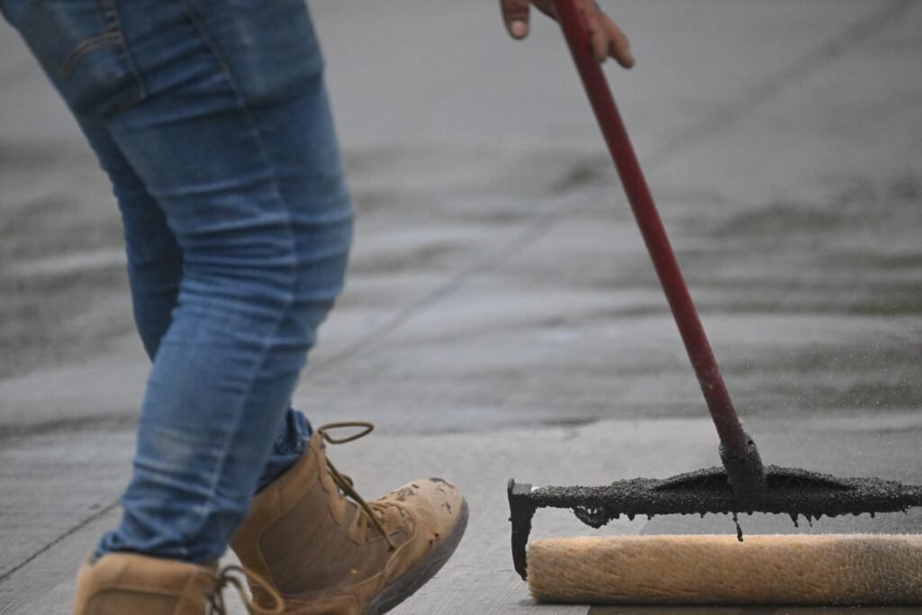 Sealer being rolled onto a concrete surface