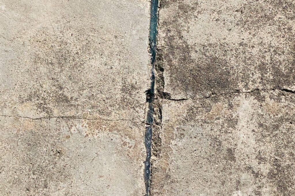 Close-up of cracked, damaged concrete that needs structural repair
