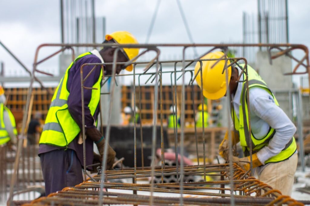 Construction crew in hard hats and safety vests working together on a repair site