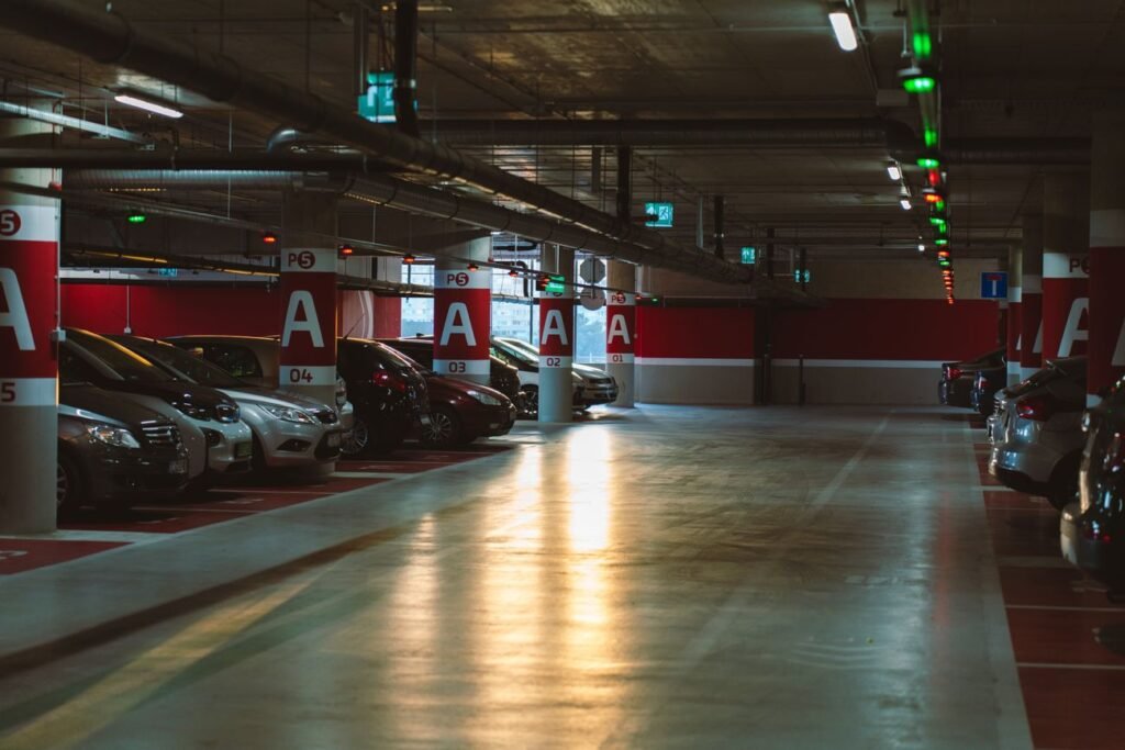Underground parking garage level with columns and parked cars ready for a Local Law 126 inspection