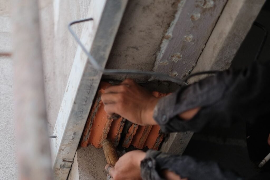 Worker repairing a concrete surface with a trowel